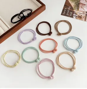 Detail of high-elastic multi-strand hair ties in various Morandi colors with knotted decor