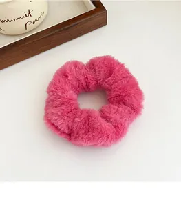Détail d'un chouchou en peluche rose foncé avec texture douce pour coiffures d'automne