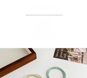 Detail view of high elasticity knotted hair ties in soft yellow and pale green colors