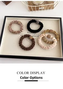 Detailed close-up of five velvet rhinestone hair scrunchies in neutral earth tones