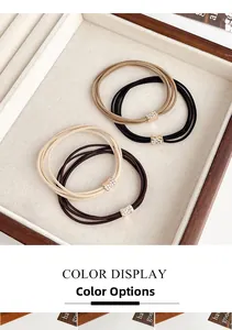 Detail of four-piece rhinestone bow hair ties in coffee and beige neutral colors