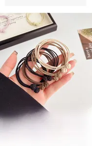 Detailed macro view of knotted high-elastic hair ties in neutral earthy color tones