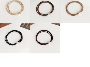 Detail of high-elastic hair ties with rhinestone cylinder decor in neutral coffee colors