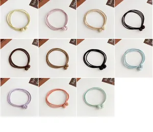 Detail of high-elasticity braided hair ties in multiple pastel colors with knots