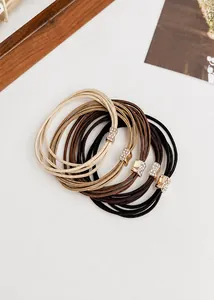 Close-up of durable multi-layer elastic hair ties with sparkling rhinestone metal buckles