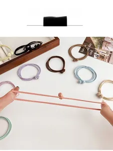 Detail view of colorful high-elasticity braided hair ties showing strong stretch performance