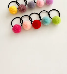 Close-up of 10 colorful plush ball hair ties showing soft texture and elastic bands