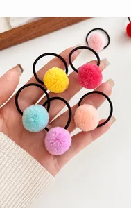 Close-up of soft candy-colored pom pom hair ties with high elasticity black bands