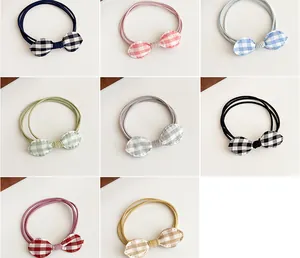 Detail of high-elasticity braided hair ties with gingham bow patterns in eight colors