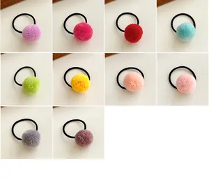 Close-up of assorted candy-colored plush pom pom hair ties with elastic bands for girls