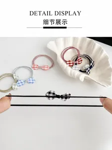 Detail view of durable high-elastic hair tie showing the stretchable checkered bow knot