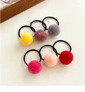 Set of six colorful plush pompom hair ties with soft elastic bands for girls