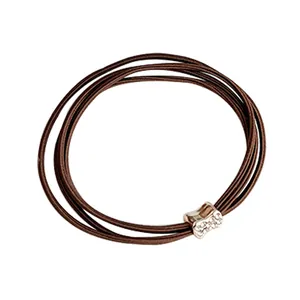 Brown multi-strand elastic hair tie with a gold rhinestone bone charm accessory