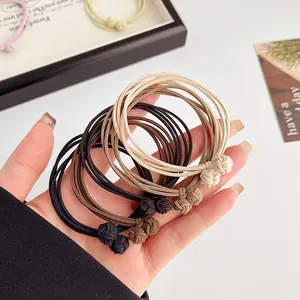 Set of 4-in-1 elastic hair ties in earth tones with stylish knotted details