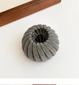 Close-up of grey flocked bird nest hair clip showing soft velvet texture and design