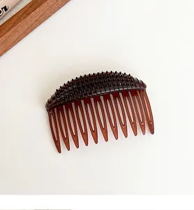 Macro detail of dark brown hair comb insert with anti-slip bumps for volume boost
