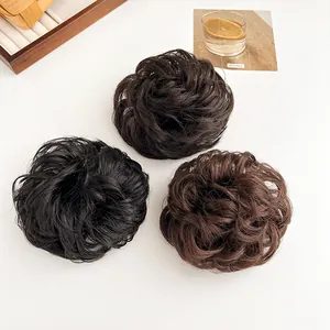 Drie pluizige knot-haarstukjes in zwart en bruin voor extra volume en een natuurlijke look