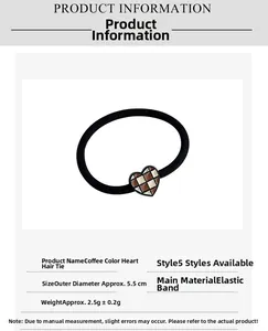 Detailed view of elastic hair tie with brown heart-shaped checkered charm and specs