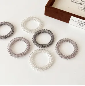 Detailed view of six gradient grey spiral hair ties arranged on a clean white background