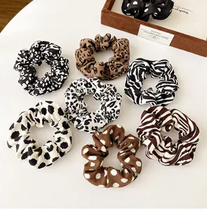 Detailed set of 7 assorted animal print scrunchies in leopard and zebra patterns