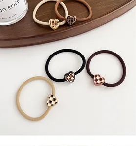 Close-up of 5-piece heart checkered hair ties set in earthy tones with elastic fabric