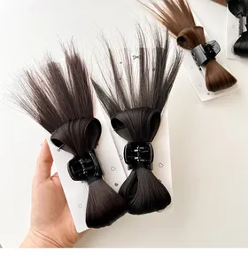 Macro detail of natural black and brown bow hair claws on white display cards