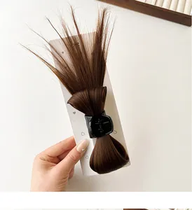 Detail of dark brown synthetic hair claw clip with bow style for high ponytail volume