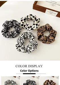 Detailed view of various animal print scrunchies including leopard and cow patterns