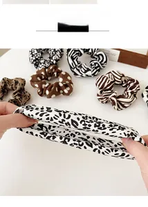 Detail view of high-elasticity hair scrunchies with leopard and zebra print patterns