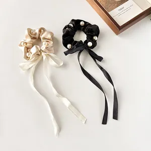 Elegant satin bow scrunchies with white faux pearls and long ribbons in beige and black