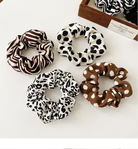 Macro detail of French vintage scrunchies featuring animal prints and polka dot textures