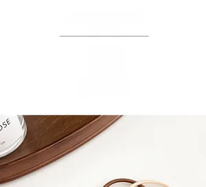 Detail of coffee-colored elastic hair ties in a wooden tray showing braided texture