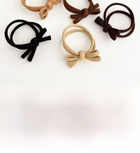 Close-up of high-elasticity coffee-toned hair ties with handcrafted bow details
