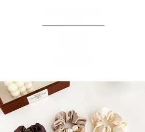 Detail showing satin scrunchies with rhinestones and faux pearls in coffee and cream tones