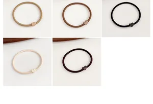Detail of high-elasticity heart hair ties in neutral matte tones for ponytail styling