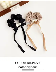 Detail of satin scrunchies with white pearls, sparkling rhinestones and elegant streamers