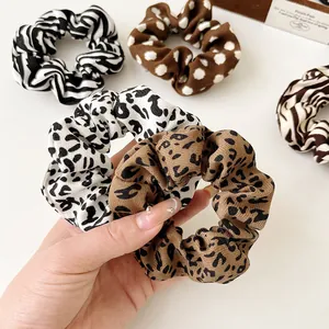 Set of five leopard and zebra print scrunchies in various vintage animal patterns