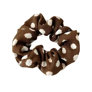 French vintage leopard pattern scrunchie with white polka dots on dark brown fabric