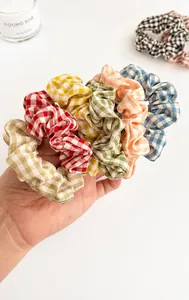 Close-up of colorful gingham fabric scrunchies in a multi-color assorted collection