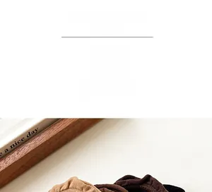 Detail of ruffled hair scrunchies in milk coffee colors showing soft velvet texture