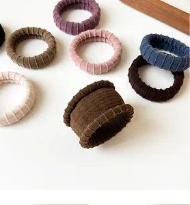 Detailed texture of thick elastic towel hair ties in various Morandi earth tones