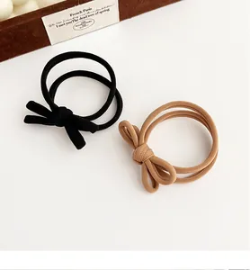 Detail of black and brown bow hair ties with elastic seamless loop design
