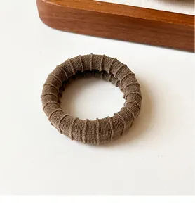 Detailed view of brown coffee ribbed knit texture on durable high-elasticity hair scrunchie