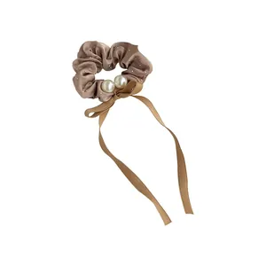 Elegant champagne satin scrunchie with rhinestones, pearls and flowing ribbon bow
