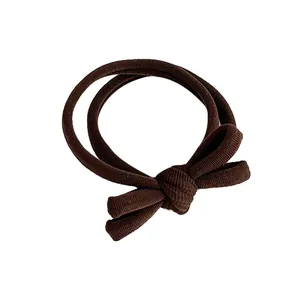 Coffee brown bow hair tie made of textured elastic ribbed fabric for daily ponytail