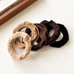 Five-piece set of ruffle scrunchies in minimalist coffee-toned colors on white background