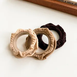 Three-piece ruffle scrunchie set in beige and coffee shades with durable elastic fabric