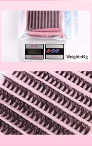 Macro detail of DIY false eyelash clusters set with tweezers and adhesive tool