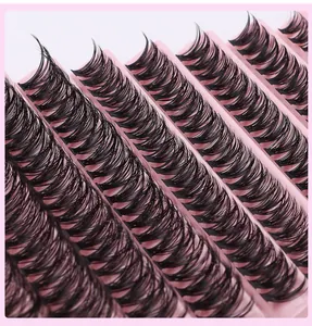Close-up of voluminous black cluster lash extensions neatly arranged on pink card