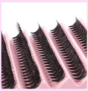 Detailed macro view of dense 40D multi-row individual lash extensions in a pink tray
